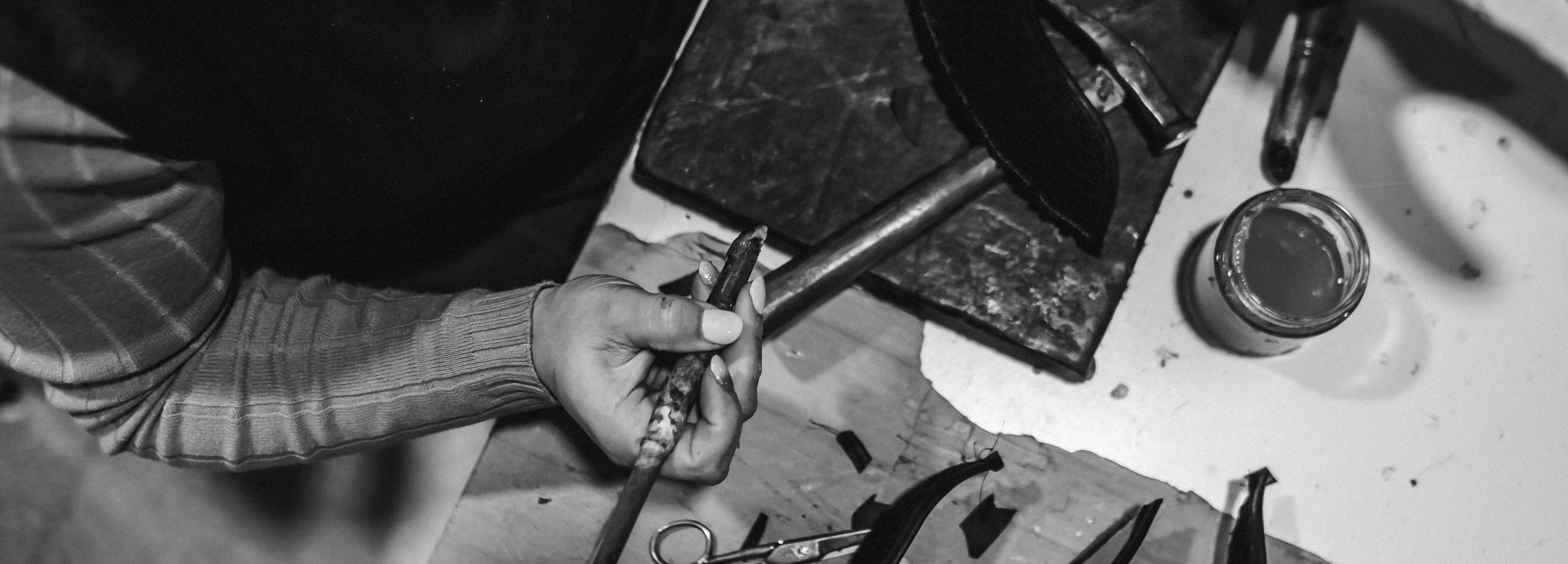 Person working with tools on a wooden surface