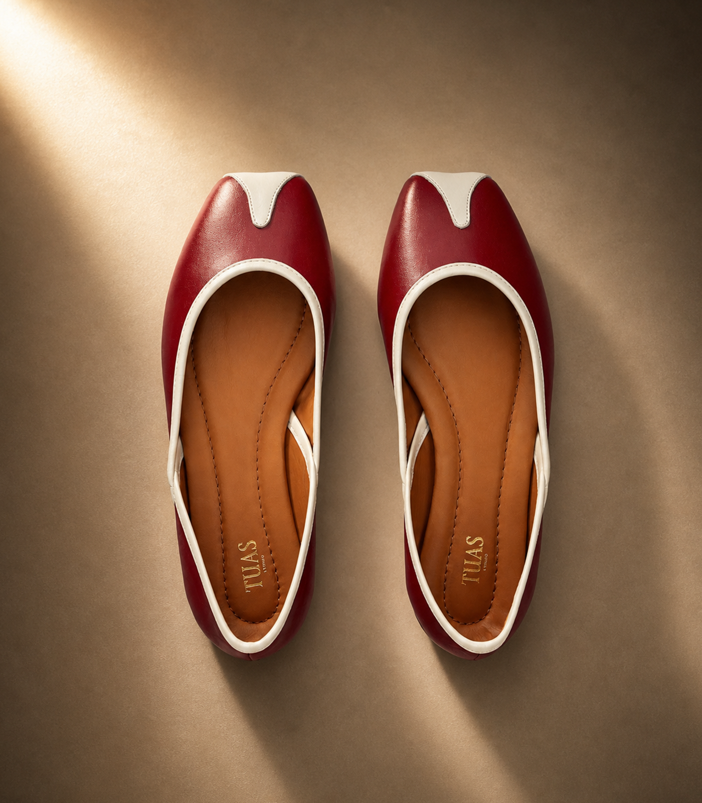 Pair of red and white shoes on a brown background