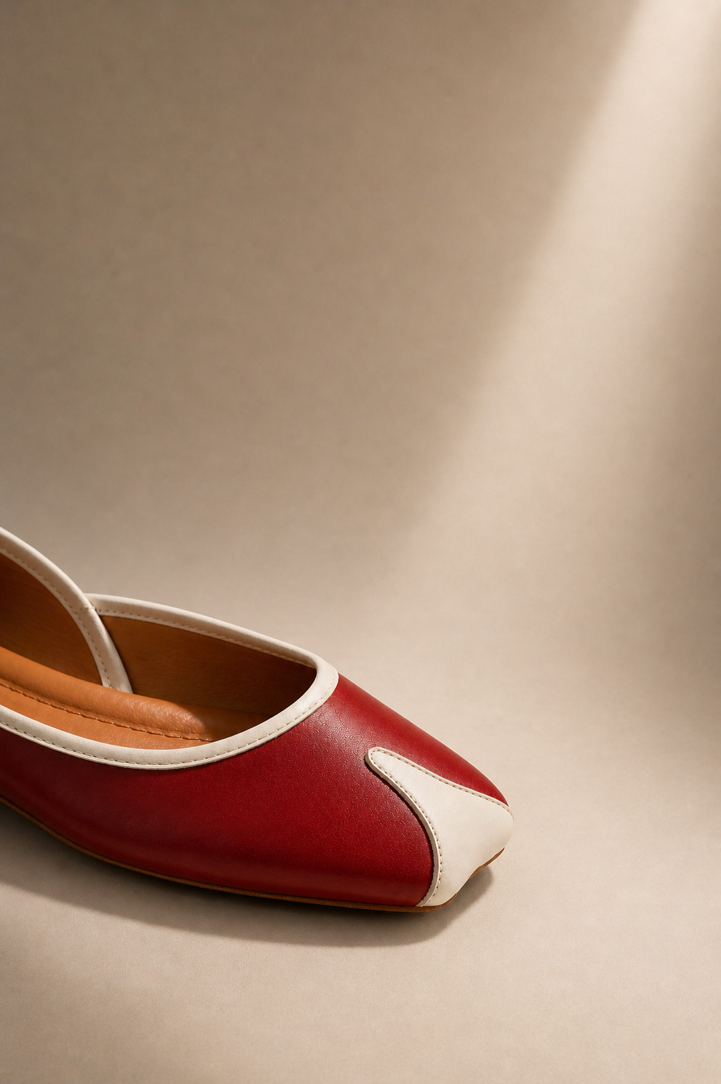 Red and white shoe on a beige background