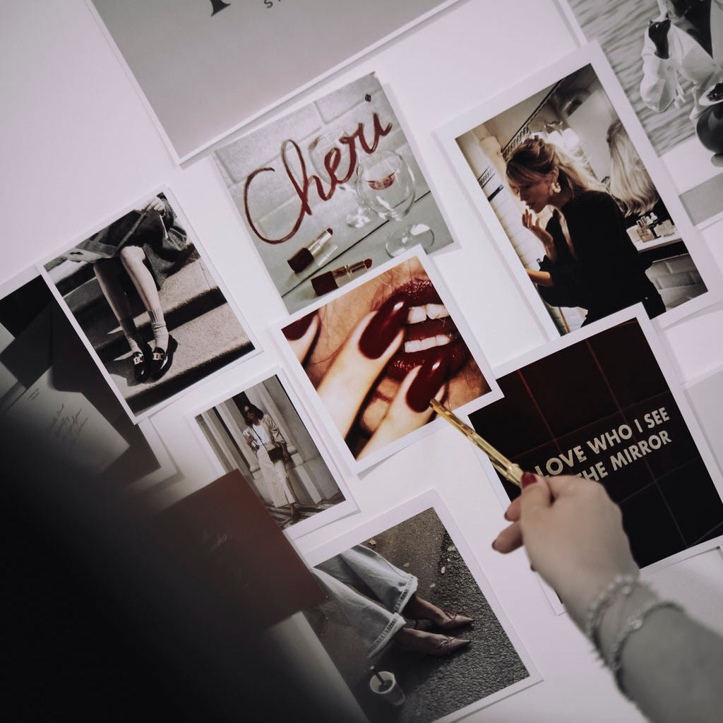 Collage of photos and text on a wall with 'TUAS STUDIO' at the top.