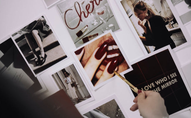 Collage of photos and text on a wall with 'TUAS STUDIO' at the top.