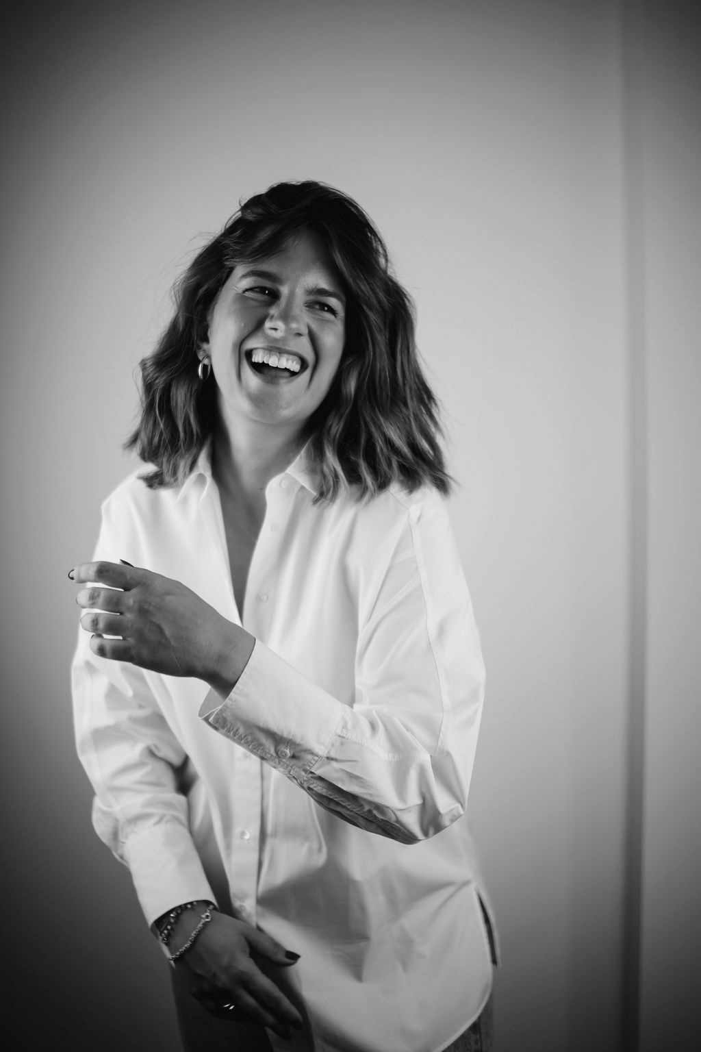 Black and white photo of a TUAS founder wearing a white shirt with a knife on her sleeve.