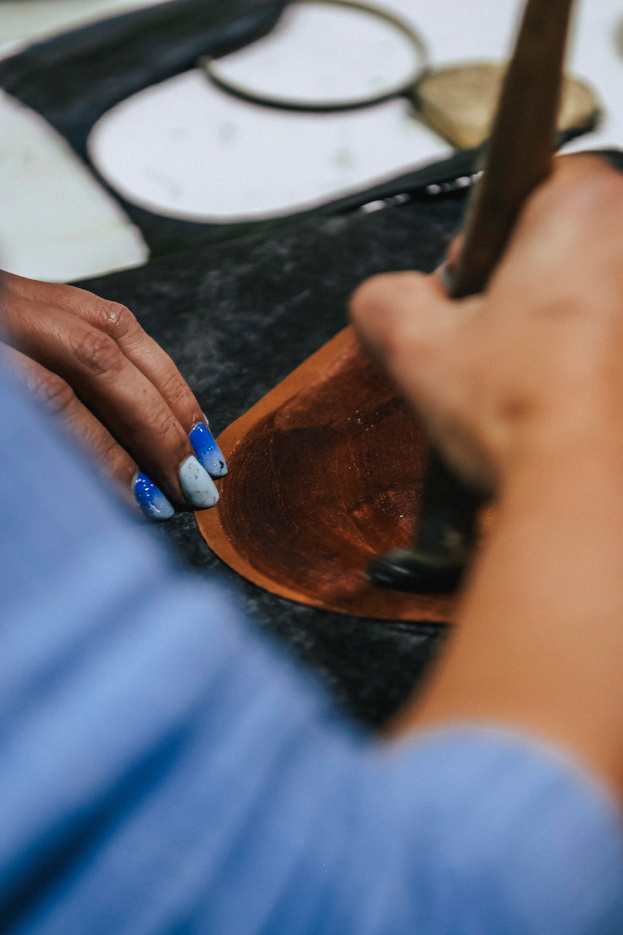 Person holding a wooden bowl with a blurred background