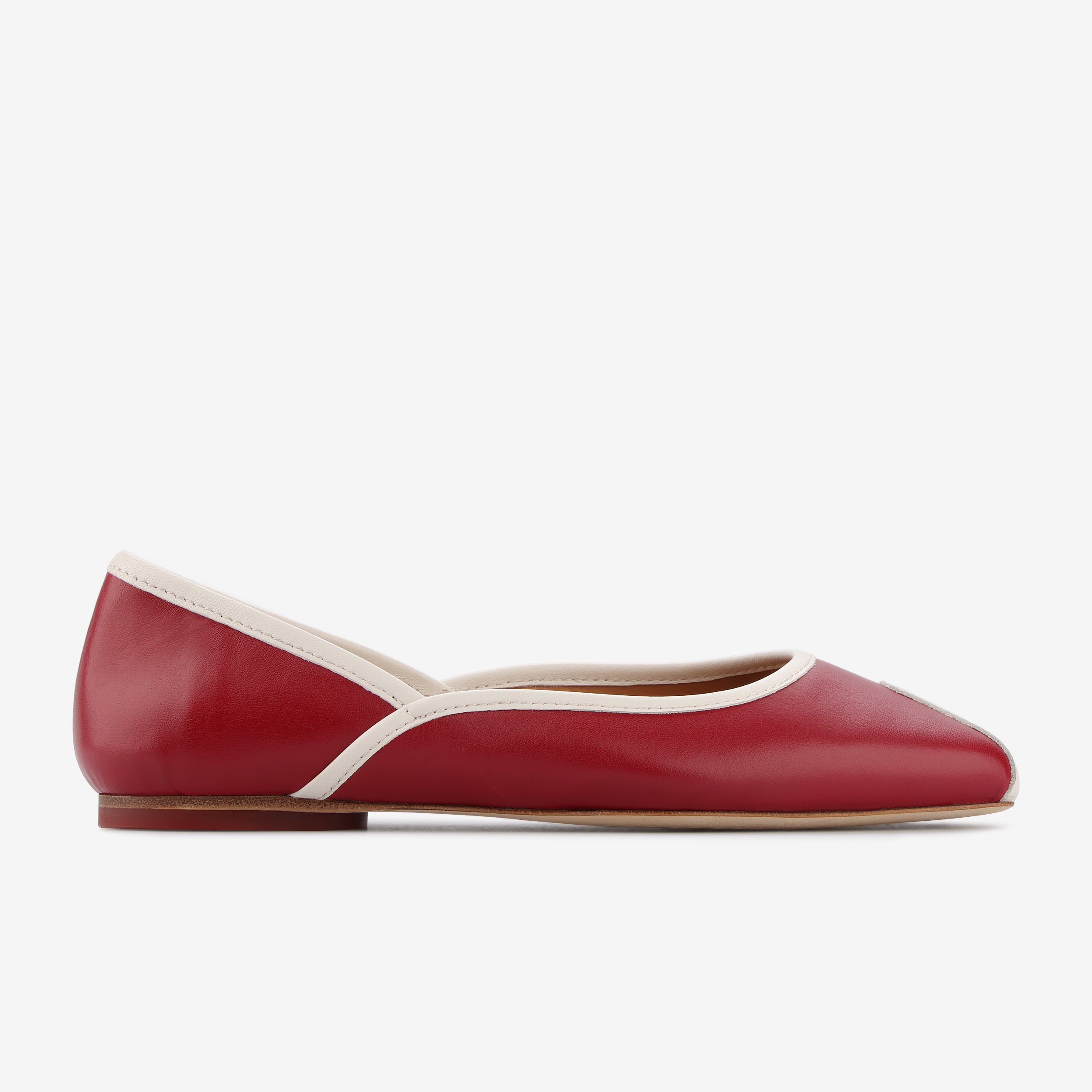 TUAS Julia winery red flat shoe with white accents on a white background