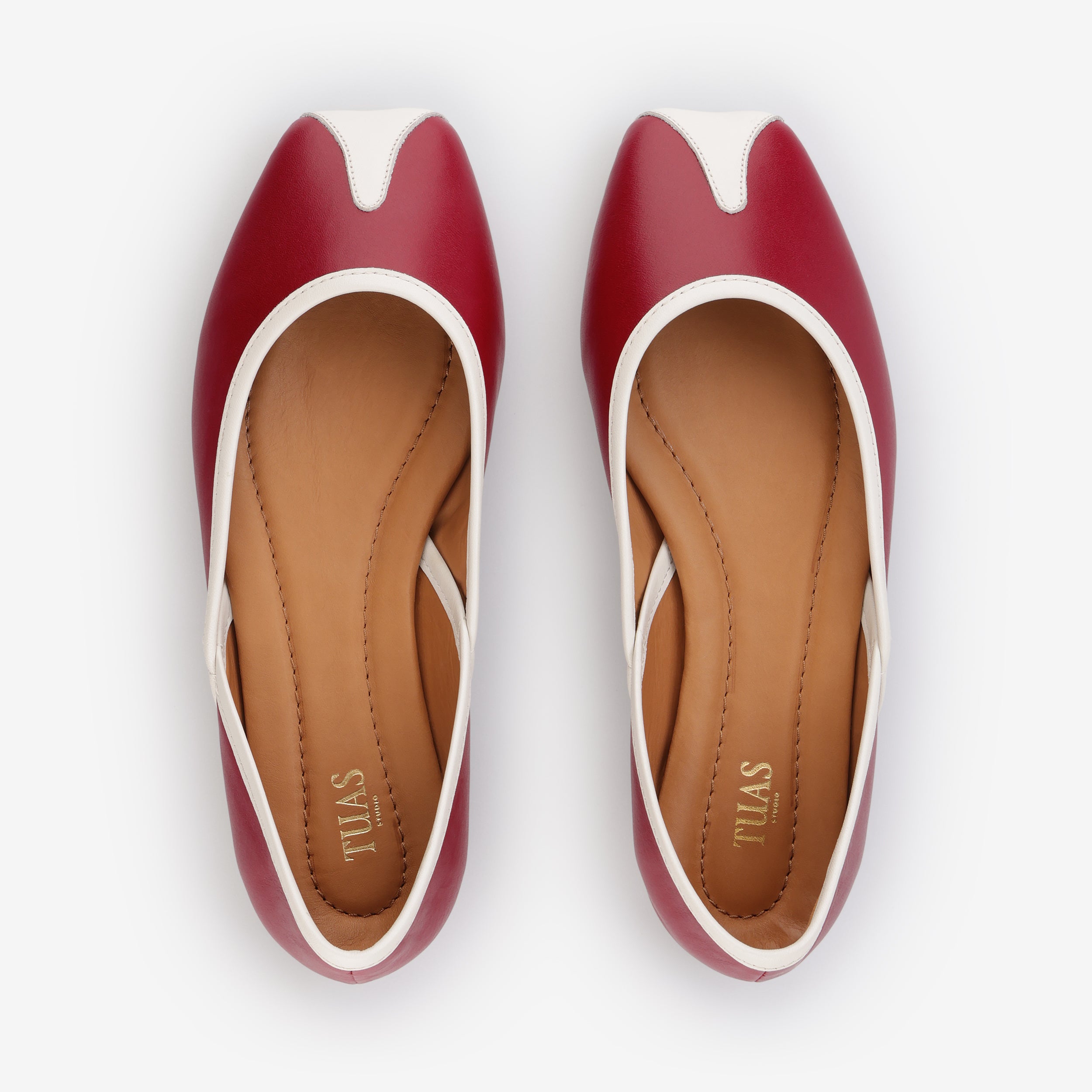 TUAS Julia winery red flat shoe with white accents on a white background
